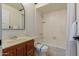 Full bathroom with a shower and tub combination, wood vanity, and neutral finishes at 12015 S Tuzigoot Dr, Phoenix, AZ 85044