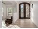 Home entrance highlighting the decorative door, hardwood floors, and interior design elements at 12015 S Tuzigoot Dr, Phoenix, AZ 85044