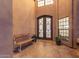 Elegant entryway featuring a decorative door, tiled floor, and a comfortable seating area at 12015 S Tuzigoot Dr, Phoenix, AZ 85044