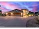 Home exterior showcasing an oversized garage and a circular driveway, all enhanced by professional landscaping at 12015 S Tuzigoot Dr, Phoenix, AZ 85044