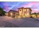 Beautifully landscaped home exterior with a circular driveway and inviting architectural design at 12015 S Tuzigoot Dr, Phoenix, AZ 85044