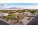 Desert home showcasing the landscaped front yard, circular driveway, and desert flora at 12015 S Tuzigoot Dr, Phoenix, AZ 85044