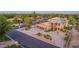 Home exterior featuring circular driveway, a three-car garage, tile roof, and desert landscaping at 12015 S Tuzigoot Dr, Phoenix, AZ 85044