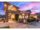 Back exterior view of a two-story home at dusk at 12015 S Tuzigoot Dr, Phoenix, AZ 85044