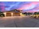 Exterior image capturing the home's spacious driveway, elegant landscaping, and architectural details at 12015 S Tuzigoot Dr, Phoenix, AZ 85044