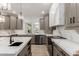 Modern kitchen showcasing stainless steel appliances, white countertops, and sleek gray cabinetry at 12015 S Tuzigoot Dr, Phoenix, AZ 85044