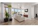 Spacious living room features large windows with pool views, wood floors, and a stylish ceiling fan at 12015 S Tuzigoot Dr, Phoenix, AZ 85044