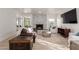 Elegant living room with a decorative fireplace, plush leather seating, and open access to other rooms at 12015 S Tuzigoot Dr, Phoenix, AZ 85044