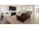 Comfortable living room with stylish decor, a large flat-screen TV, and an open layout leading to other rooms at 12015 S Tuzigoot Dr, Phoenix, AZ 85044