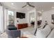 Bright, open living room showcasing modern seating, a flat-screen TV, and views into the kitchen at 12015 S Tuzigoot Dr, Phoenix, AZ 85044