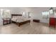 Large main bedroom with dark wood furnishings, bright windows, and light colored flooring at 12015 S Tuzigoot Dr, Phoenix, AZ 85044