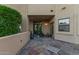 Outdoor patio with decorative tile, enhancing the home's exterior living space with lush greenery at 12015 S Tuzigoot Dr, Phoenix, AZ 85044