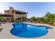 An in-ground pool with the backyard and home in the background, showing an outdoor oasis at 12015 S Tuzigoot Dr, Phoenix, AZ 85044