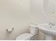 Half bathroom featuring a toilet and pedestal sink with chrome hardware and white walls at 12041 W Fillmore St, Avondale, AZ 85323