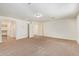 Large carpeted bedroom with neutral walls, multiple doorways, and recessed lighting at 12041 W Fillmore St, Avondale, AZ 85323