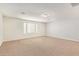 Spacious carpeted bedroom with a large window allowing natural light and neutral color palette at 12041 W Fillmore St, Avondale, AZ 85323