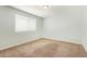 This is a bedroom with neutral carpet, light blue walls, and a window for natural light at 12041 W Fillmore St, Avondale, AZ 85323