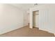 Bedroom featuring carpet, a closet with doors, and neutral-toned walls at 12041 W Fillmore St, Avondale, AZ 85323