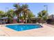 Community pool and park with lush green palm trees, seating area and playground perfect for families to enjoy at 12041 W Fillmore St, Avondale, AZ 85323