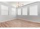 Bright dining room with wood-look tile flooring and a modern chandelier at 12041 W Fillmore St, Avondale, AZ 85323