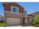 Charming two-story home with a two-car garage, craftsman architecture, and nicely landscaped front yard at 12041 W Fillmore St, Avondale, AZ 85323