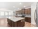 Modern kitchen featuring stainless appliances, island and open design into dining room at 12041 W Fillmore St, Avondale, AZ 85323
