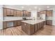 Spacious kitchen featuring a center island, stainless steel appliances, and granite counters at 12041 W Fillmore St, Avondale, AZ 85323