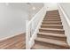 A carpeted staircase with white railing connects the levels, enhancing home's accessibility at 12041 W Fillmore St, Avondale, AZ 85323