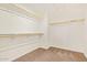 Walk-in closet with carpet, shelving, and natural light at 12041 W Fillmore St, Avondale, AZ 85323