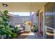 Relaxing covered balcony with a gray sofa, potted plants, and outdoor decor at 1225 E Medlock Dr # 206, Phoenix, AZ 85014