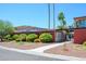 Well-maintained condo complex entrance featuring lush landscaping, palm trees, and signage at 1225 E Medlock Dr # 206, Phoenix, AZ 85014