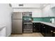 Well-equipped kitchen featuring stainless steel appliances, modern cabinetry, and a unique geometric backsplash at 1225 E Medlock Dr # 206, Phoenix, AZ 85014