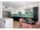 A stylish kitchen with black and white cabinets, modern lighting, and a unique geometric backsplash at 1225 E Medlock Dr # 206, Phoenix, AZ 85014