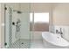 Modern bathroom featuring a glass enclosed shower with rainfall shower head and a freestanding tub at 12730 N 90Th Way, Scottsdale, AZ 85260