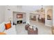Bright living room featuring stone fireplace, and open to dining area, with neutral tones and tile flooring at 12730 N 90Th Way, Scottsdale, AZ 85260