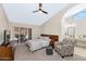 Spacious main bedroom with a ceiling fan, a king bed, and patio access at 12730 N 90Th Way, Scottsdale, AZ 85260