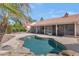 A stunning freeform backyard pool with mature landscaping and a tiled-roofed structure at 12730 N 90Th Way, Scottsdale, AZ 85260