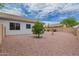 Spacious backyard with low maintenance landscaping and view of the home's exterior and detached shed at 13368 W Rimrock St, Surprise, AZ 85374