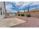 Backyard with low maintenance landscaping and a concrete patio area with detached storage shed at 13368 W Rimrock St, Surprise, AZ 85374