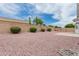 Large backyard with low maintenance desert landscaping, block wall fence, and small patio area at 13368 W Rimrock St, Surprise, AZ 85374