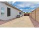 Concrete patio area with low maintenance desert landscaping and block wall fence for backyard privacy at 13368 W Rimrock St, Surprise, AZ 85374