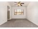 Neutral bedroom featuring carpet, ceiling fan, and a window letting in natural light at 13368 W Rimrock St, Surprise, AZ 85374