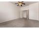 Neutral bedroom featuring carpet, ceiling fan, and entry to another room at 13368 W Rimrock St, Surprise, AZ 85374
