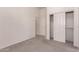 Well-lit bedroom featuring neutral tones, with carpeting and ample closet space for storage at 13368 W Rimrock St, Surprise, AZ 85374