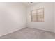 Bright and airy bedroom with a large window offering natural light and neutral carpeting at 13368 W Rimrock St, Surprise, AZ 85374