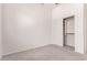 This spacious bedroom features a closet and fan with neutral carpeting and a light color palette at 13368 W Rimrock St, Surprise, AZ 85374