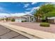 Charming home with a desert landscape, palm trees, and 3-car garage at 13368 W Rimrock St, Surprise, AZ 85374