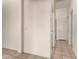 Bright hallway featuring tile flooring, white walls, and doors leading to various rooms at 13368 W Rimrock St, Surprise, AZ 85374