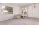 Bright living room features neutral carpeting, large windows, and contemporary lighting at 13368 W Rimrock St, Surprise, AZ 85374