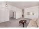 Open-concept living space with neutral carpet and access to dining area at 13368 W Rimrock St, Surprise, AZ 85374